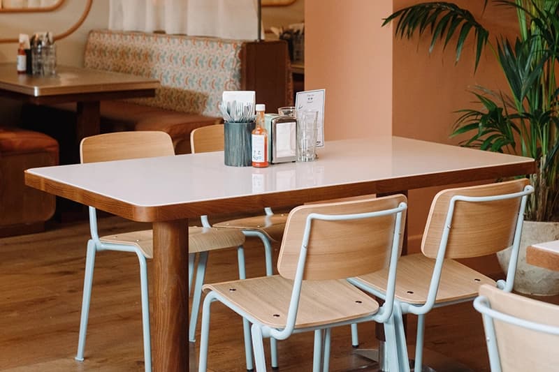 Table laid for four diners with booth visible behind