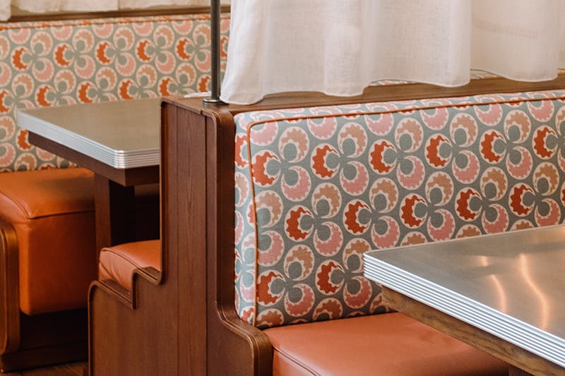 Close-up of the patterned backrest of a booth with wooden support